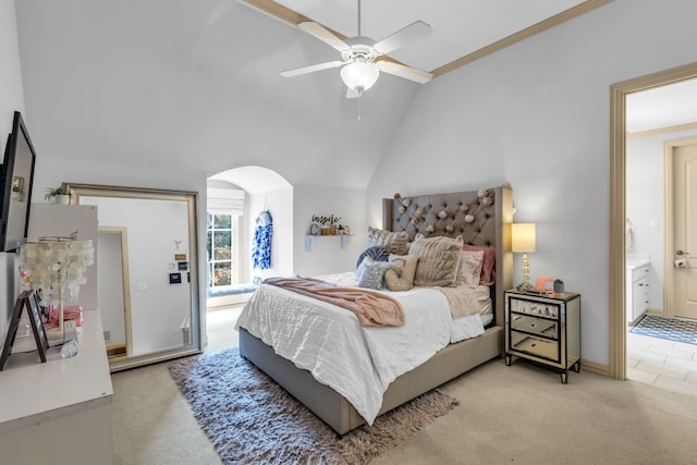 carpeted bedroom with ceiling fan, ensuite bath, lofted ceiling, and crown molding