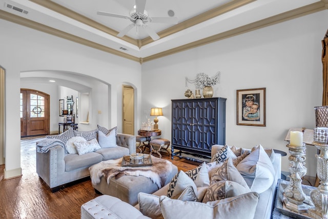 living room with crown molding, ceiling fan, and dark hardwood / wood-style flooring