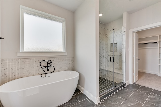 bathroom featuring shower with separate bathtub