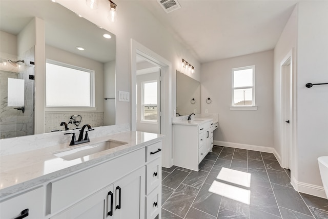 bathroom featuring vanity and tiled shower