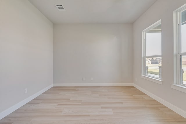 unfurnished room with light hardwood / wood-style flooring