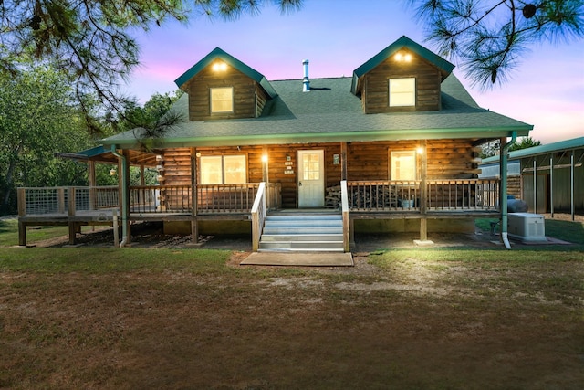 log cabin with a lawn