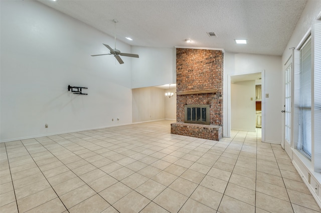 unfurnished living room featuring light tile patterned flooring, a textured ceiling, high vaulted ceiling, a fireplace, and ceiling fan with notable chandelier