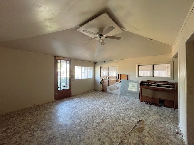 interior space featuring ceiling fan, lofted ceiling, and plenty of natural light