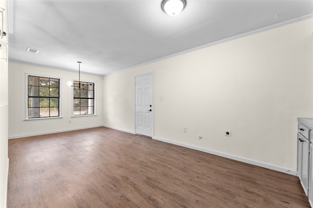 unfurnished room featuring ornamental molding and dark hardwood / wood-style floors