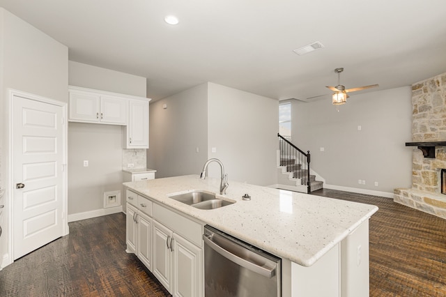 kitchen featuring white cabinets, dishwasher, sink, and an island with sink