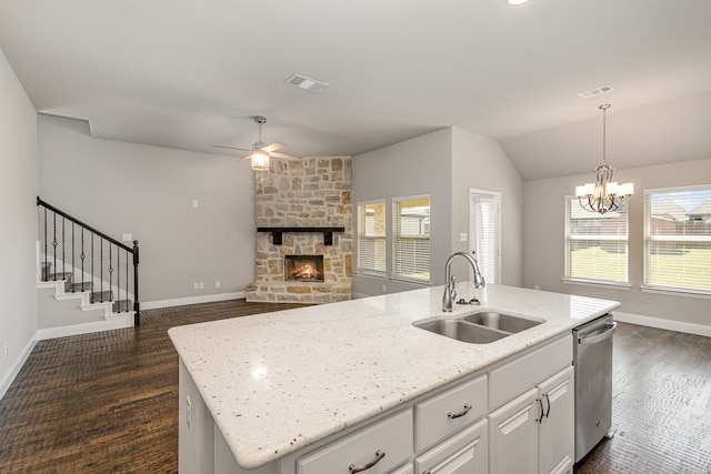 kitchen with an island with sink, stainless steel dishwasher, a healthy amount of sunlight, and sink