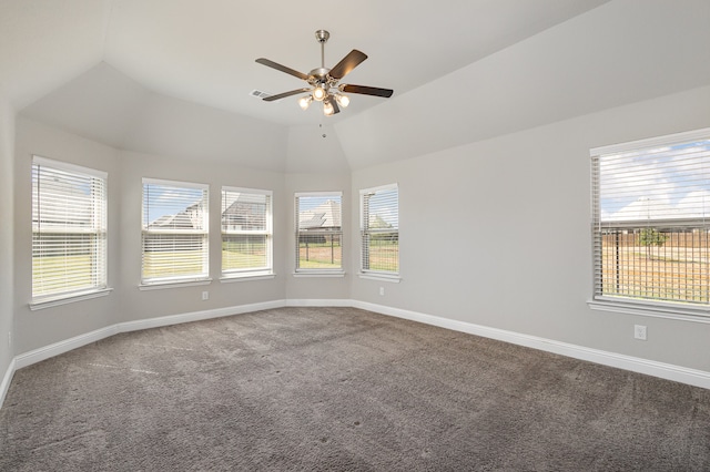 carpeted spare room with a wealth of natural light, lofted ceiling, and ceiling fan