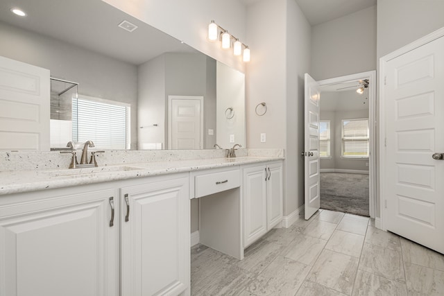 bathroom featuring ceiling fan, walk in shower, and vanity