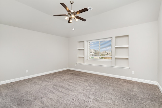 unfurnished room with carpet flooring, ceiling fan, and built in features