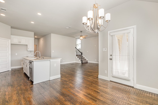 kitchen featuring hanging light fixtures, white cabinets, ceiling fan, a center island with sink, and dark hardwood / wood-style floors