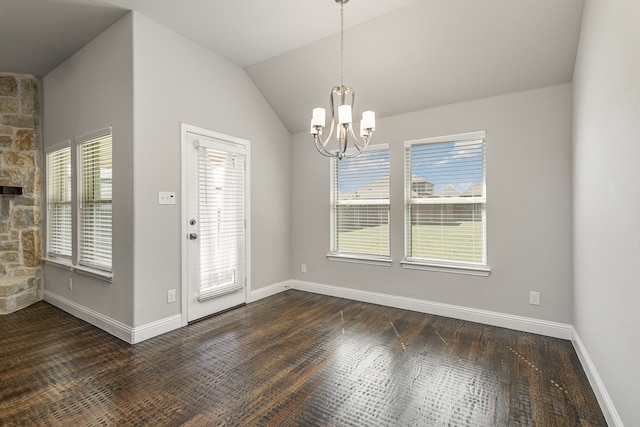 interior space with a notable chandelier, vaulted ceiling, and dark hardwood / wood-style floors