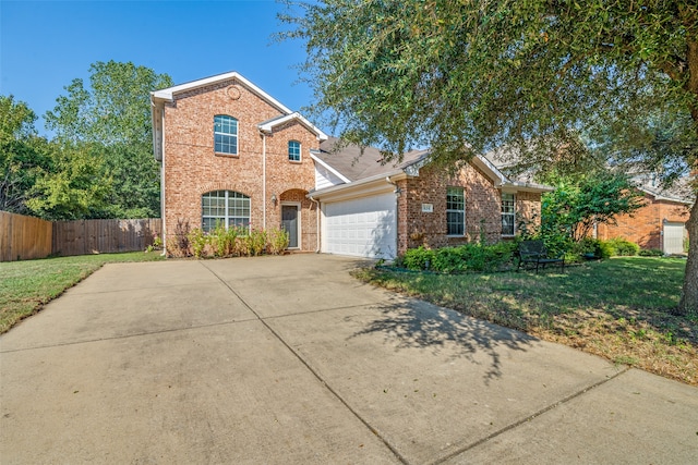 front of property with a front yard and a garage