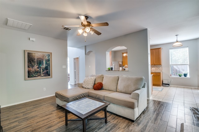 living room with ceiling fan and hardwood / wood-style flooring