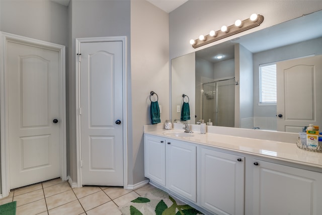 bathroom featuring tile patterned flooring, an enclosed shower, and vanity