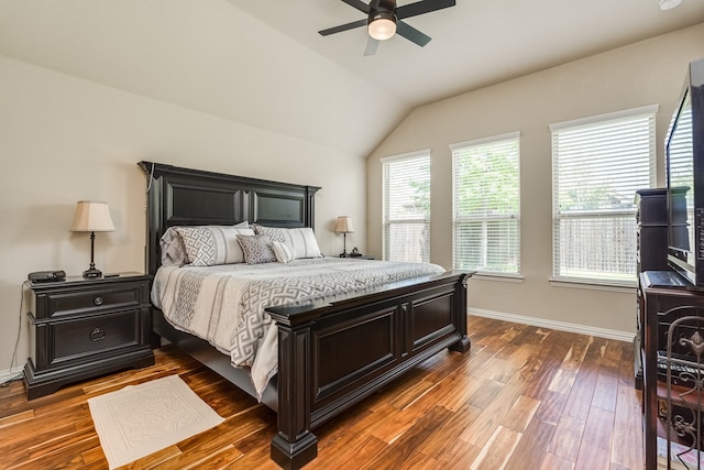 bedroom with ceiling fan, vaulted ceiling, and dark hardwood / wood-style floors