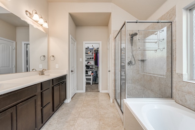 bathroom featuring tile patterned flooring, plus walk in shower, and vanity