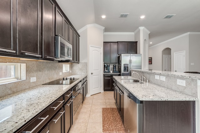 kitchen with stainless steel appliances, light stone countertops, ornamental molding, and sink