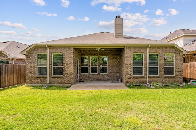 back of house featuring a lawn and a patio area