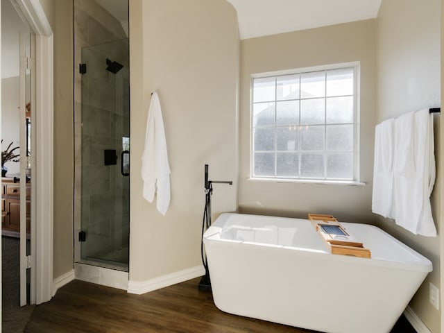 bathroom with hardwood / wood-style floors and separate shower and tub