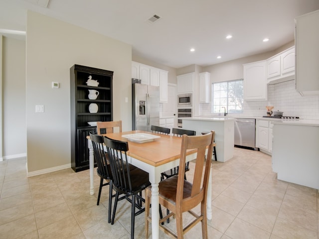 dining area with sink and light tile patterned floors