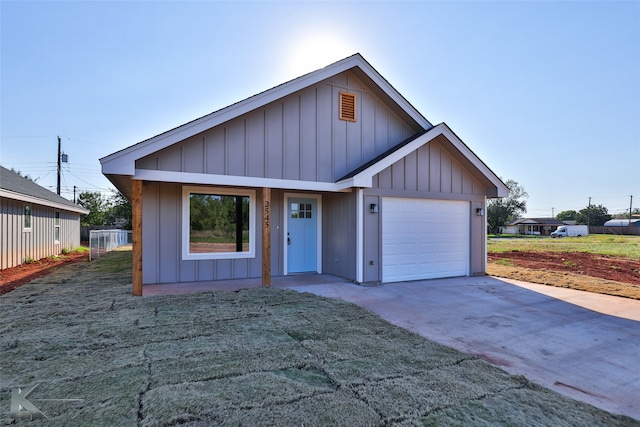 view of front of property with a garage and a front lawn