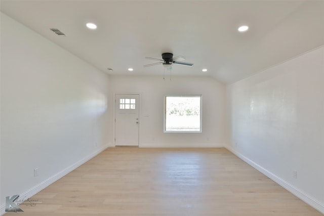 unfurnished room featuring light hardwood / wood-style floors, lofted ceiling, and ceiling fan