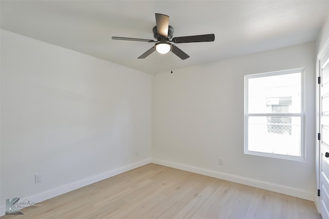 spare room with light wood-type flooring and ceiling fan