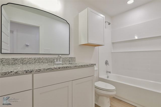 full bathroom featuring vanity, hardwood / wood-style floors, toilet, and shower / bathtub combination