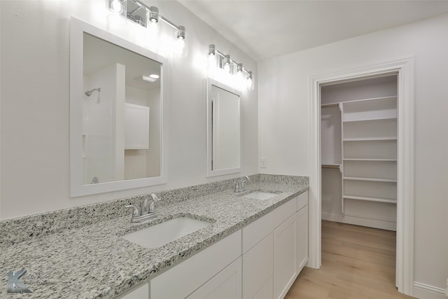 bathroom featuring vanity, a shower, and hardwood / wood-style floors