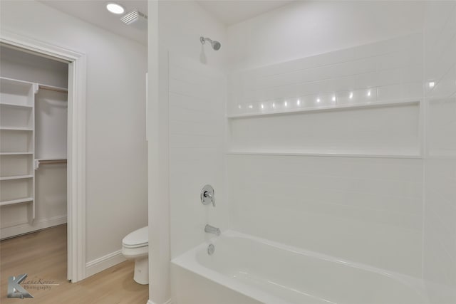 bathroom featuring toilet, shower / bathing tub combination, and wood-type flooring