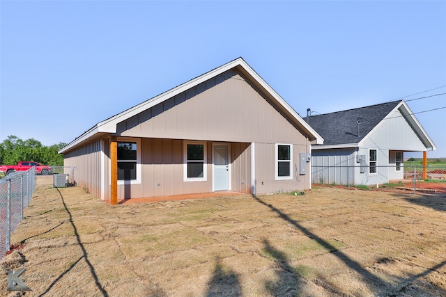 rear view of house with central AC unit