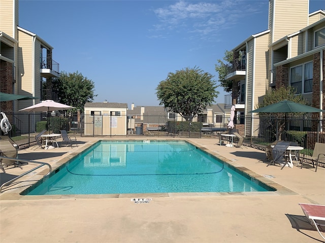 pool featuring a patio and fence