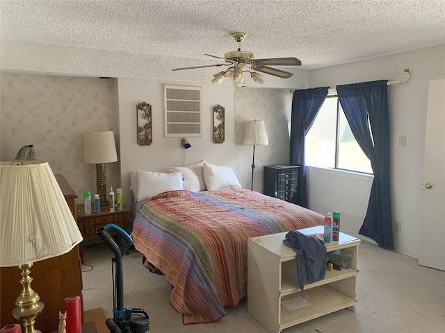 carpeted bedroom featuring a textured ceiling, ceiling fan, and wallpapered walls