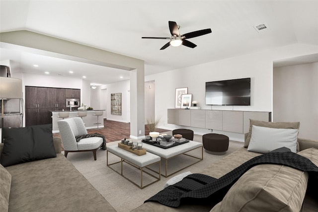 living room featuring visible vents, recessed lighting, a ceiling fan, and vaulted ceiling