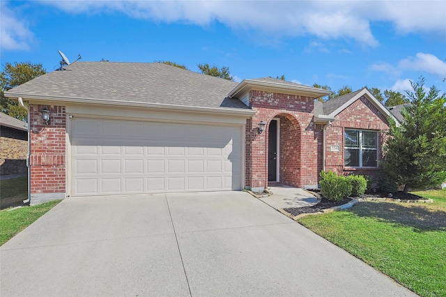 view of front of property with a front lawn and a garage