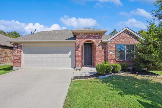 view of front of property featuring a garage and a front lawn