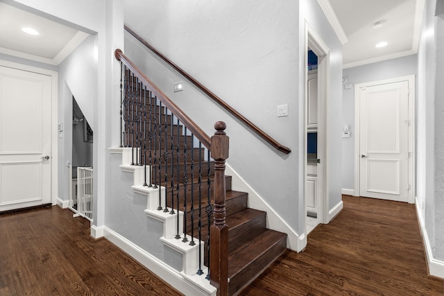 stairs featuring hardwood / wood-style floors and ornamental molding