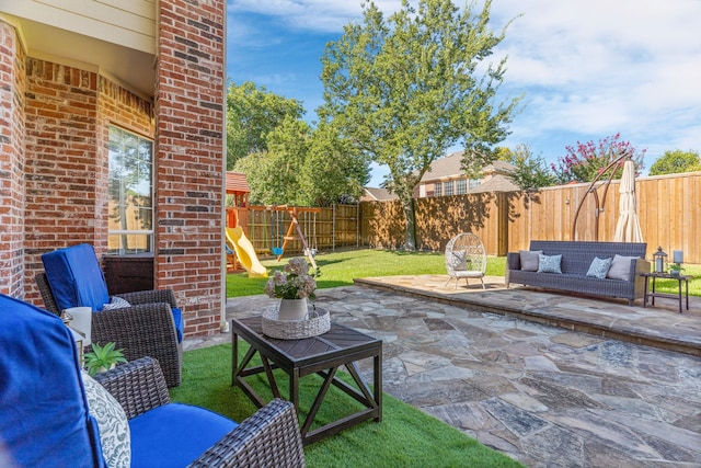 view of patio with a playground and an outdoor living space