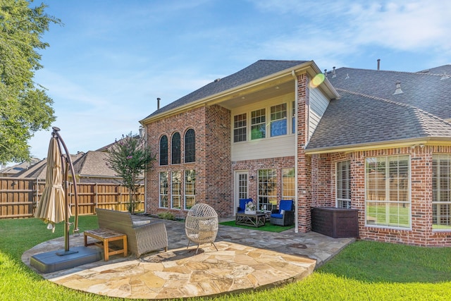 rear view of property with a patio area and a lawn