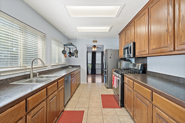 kitchen featuring ceiling fan, light tile patterned floors, appliances with stainless steel finishes, and sink