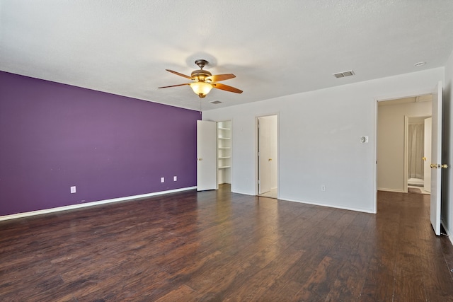 unfurnished room featuring a textured ceiling, ceiling fan, and dark hardwood / wood-style flooring