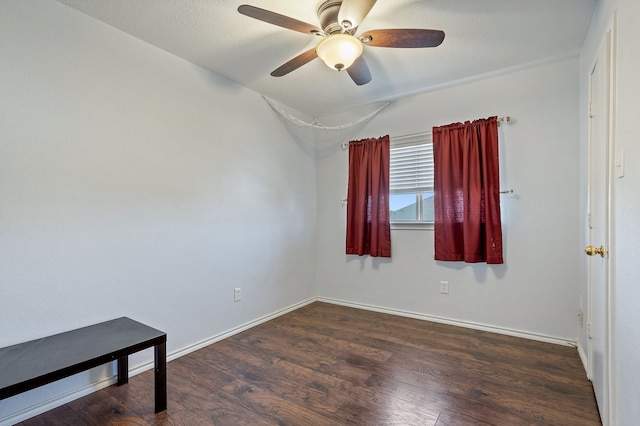 unfurnished room featuring ceiling fan and dark hardwood / wood-style floors