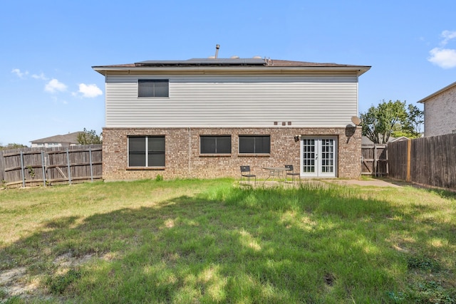 rear view of house with a lawn