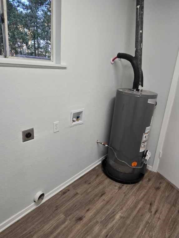 utility room featuring gas water heater