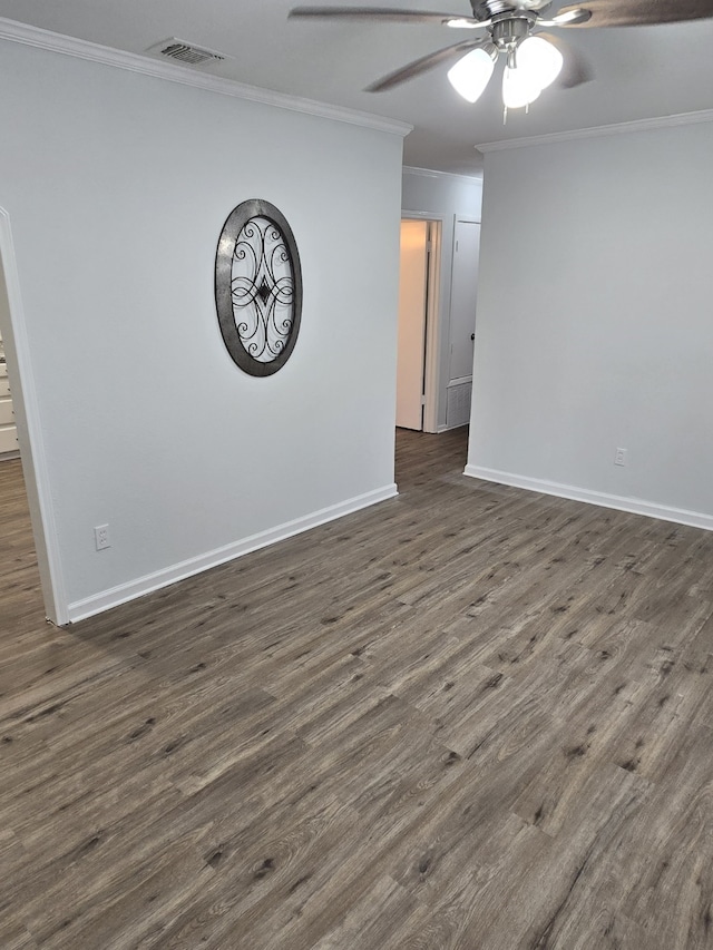 spare room featuring crown molding, dark hardwood / wood-style flooring, and ceiling fan