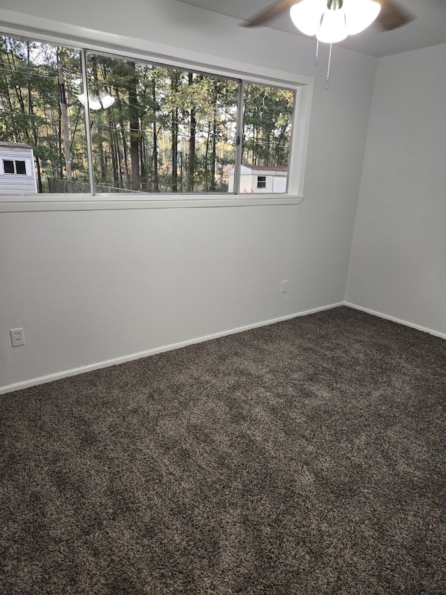 empty room with ceiling fan and carpet flooring