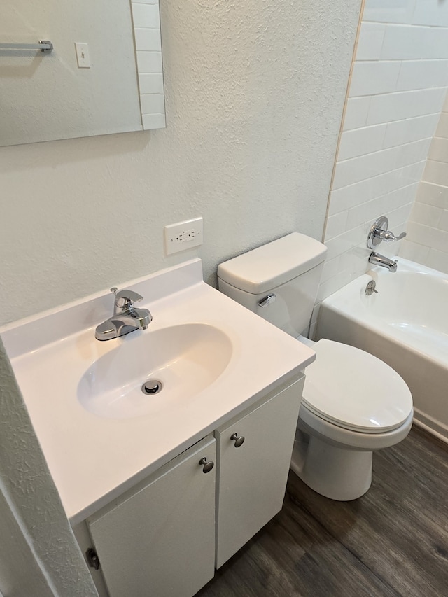 bathroom with hardwood / wood-style floors, vanity, and toilet