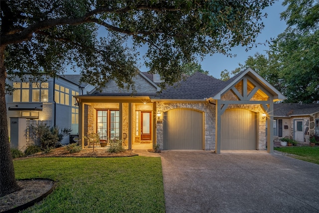 view of front of property featuring a garage and a front yard