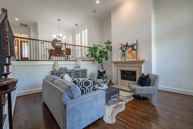 living room with crown molding, an inviting chandelier, and dark hardwood / wood-style floors